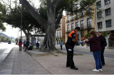 Un miembro de Protección Civil entrega mascarillas a pasajeros de autobuses (ÁLEX ZEA/EUROPA PRES) Un miembro de Protección Civil entrega mascarillas a pasajeros de autobuses (ÁLEX ZEA/EUROPA PRES)