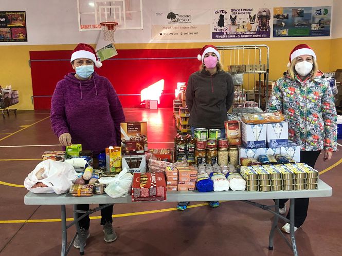 los voluntarios del Reparto Municipal de Alimentos y la concejala de Vegas junto a las cestas de Navidad (AYTO. VEGAS DEL GENIL)